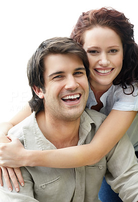 Smiling romantic couple sitting together against white