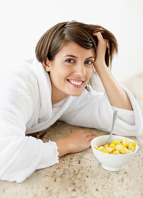 Lazy female at the kitchen counter with a bowl of fresh fruits