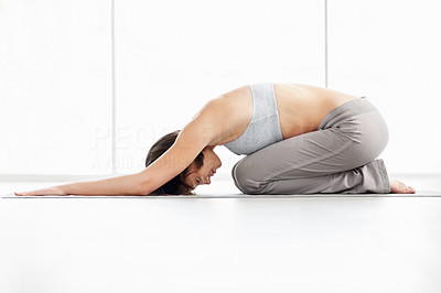 Virasana - Young fitness woman practicing yoga on the mat