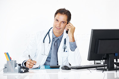 Portrait of doctor talking on the phone in office