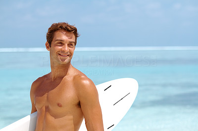 Smart young man with a surfboard at the beach