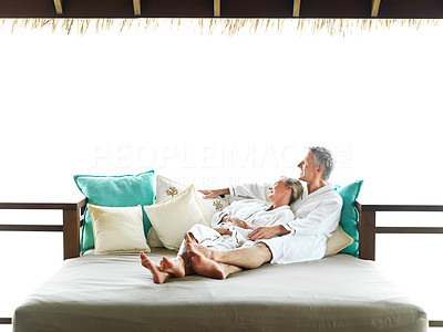 Relaxing vacation - Mature couple lying on bed in hotel room