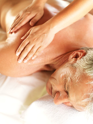 Mature man receiving a relaxing back massage at spa