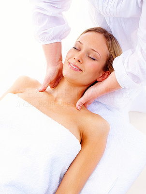 Happy cute woman getting herself a body massage by a masseuse