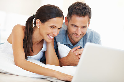 Busy couple using laptop