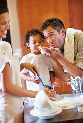 Family enjoying cleaning utensil together