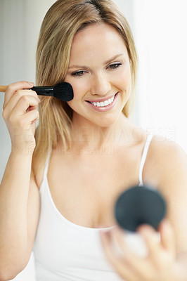 Cute woman applying makeup , getting ready for something special