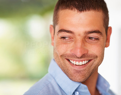 Cheerful young man looking at something interesting