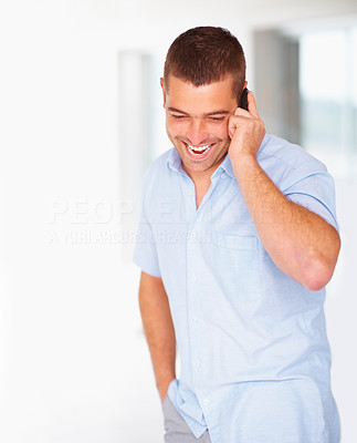Happy young guy talking on mobile phone