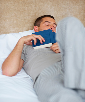 Young guy sleeping with book - Indoor