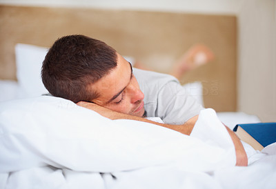 Young guy sleeping on his bed at home