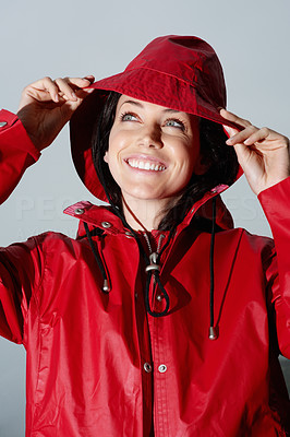 Lovely young Caucasian woman in a red raincoat