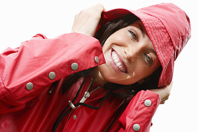 Smiling charming woman in red raincoat against white