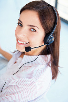 Closeup of a happy young customer representative wearing headset
