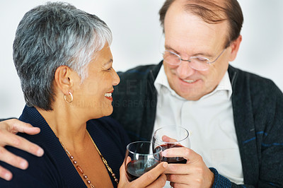 Happy elderly couple having a glass of wine together
