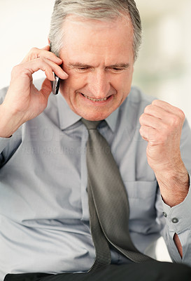 Closeup of an excited business man taking over cell phone