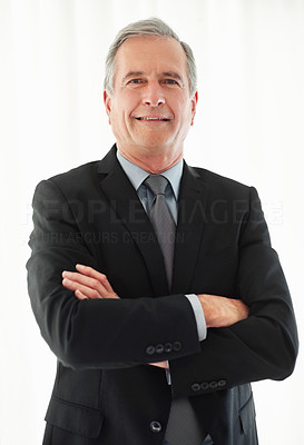 Happy business man with hands folded against white