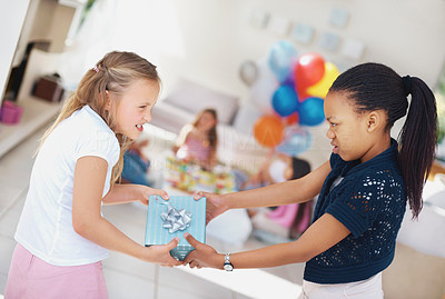 Young girls fighting over a gift at the birthday party