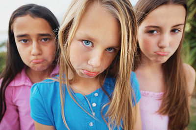 Sad little girls standing together and making a face