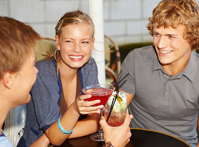 Portrait of smiling men and woman having cocktails