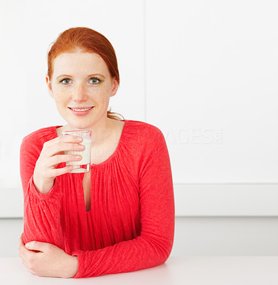 Young happy woman drinking milk
