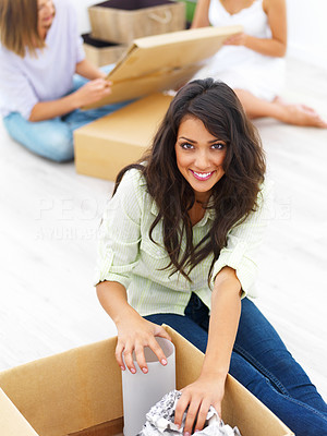 Happy young woman unpacking