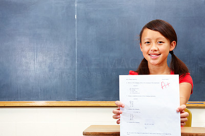 Closeup of a happy young girl showing exam results