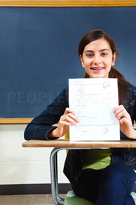 Closeup of a happy young girl showing exam results