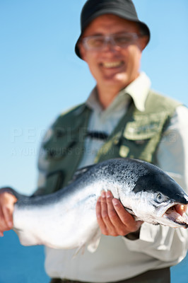 Proud fisherman holding catch