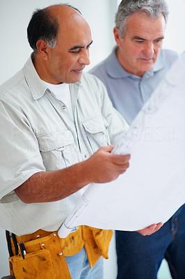 Home improvement worker going through the blueprints