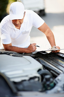 Automobile engineer checking the engine on a car