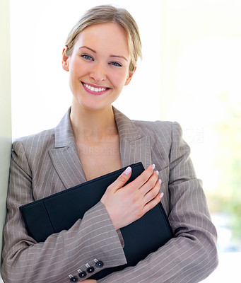 Young beautiful business woman smiling, holding a folder