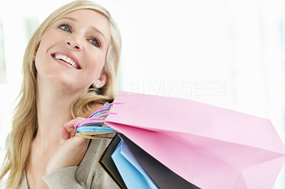 Happy Caucasian girl holding shopping bags with copyspace