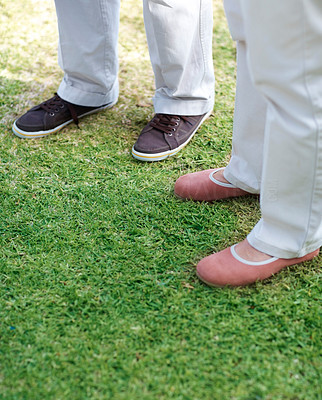 Couple standing together on the green field