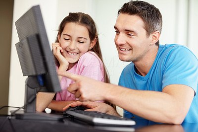 Father and his daughter sitting in front of computer!