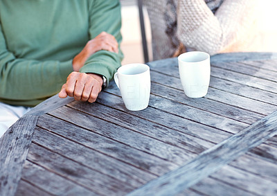 Old couple sitting together at table with coffee