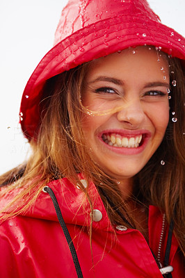 Closeup portrait of a cute young girl in a red raincoat