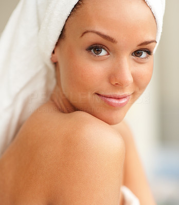 Closeup of smiling female with towel wrapped after taking bath
