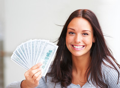 Portrait of young female holding money in the hand