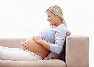 Happy pregnant woman holding her tummy
