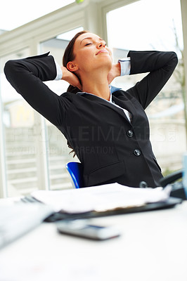 Portrait of businesswoman in black suit relaxing in the office