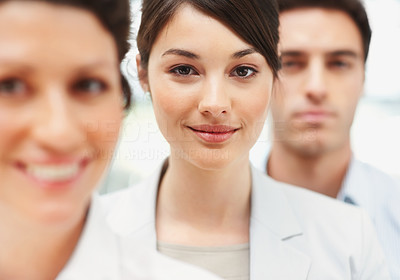 Smiling business woman standing in line with colleagues