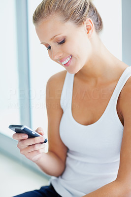Happy woman reading a text message