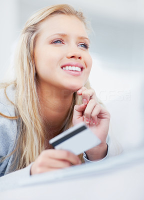 Cute happy girl shopping online with a credit card