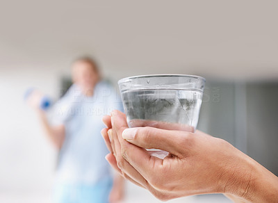 Closeup of a human hands holding a glass of water