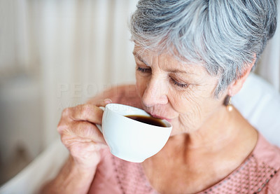 Closeup portrait of a senior woman drinking tea