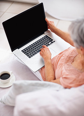 Top view of an old woman using a laptop at home