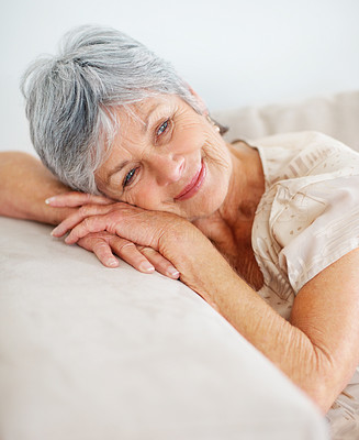 Closeup of a happy senior woman relaxing on a couch