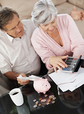 Senior couple calculating their personal finances at home