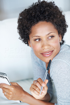 Woman writing on couch